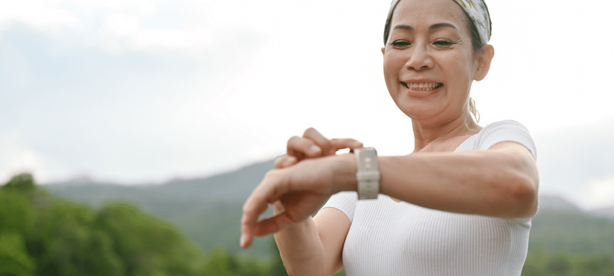 woman looking at smartwatch