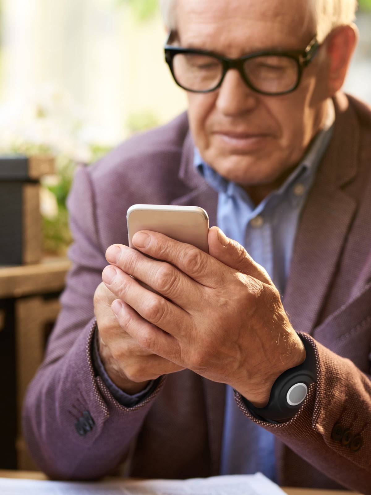 Man wearing Medical Alert help button using the Medical Alert mobile app