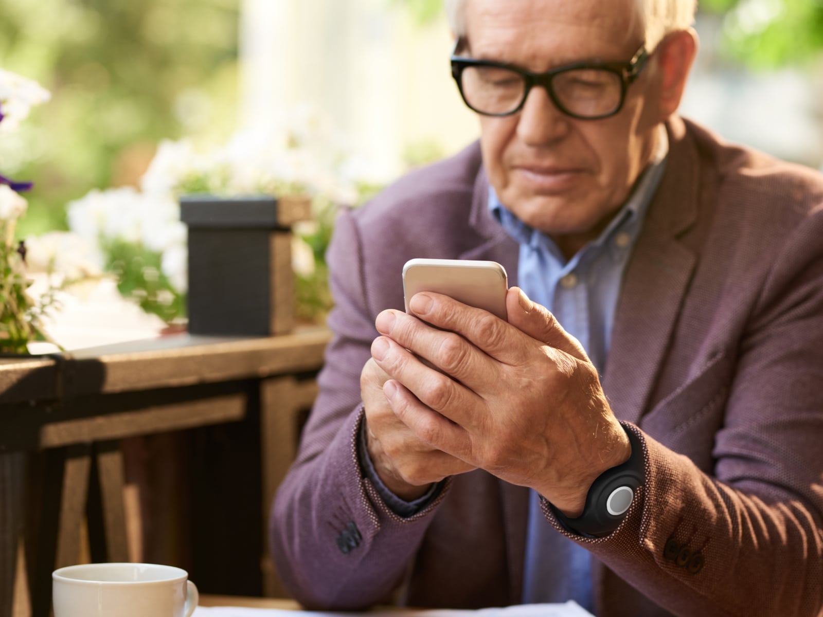 Man wearing Medical Alert help button using the Medical Alert mobile app