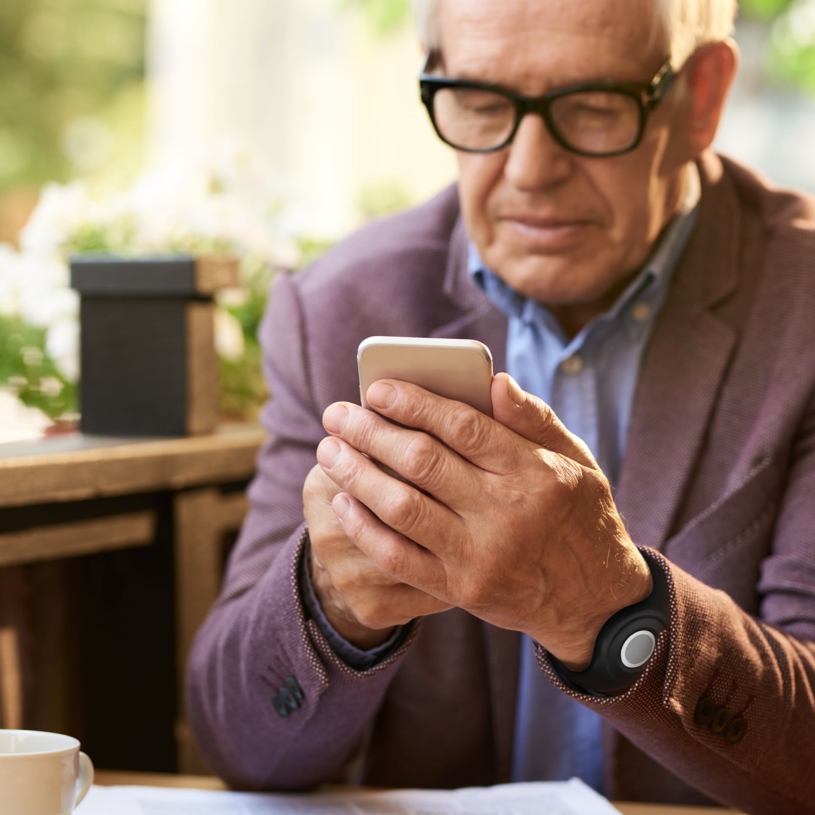 Man wearing Medical Alert help button using the Medical Alert mobile app