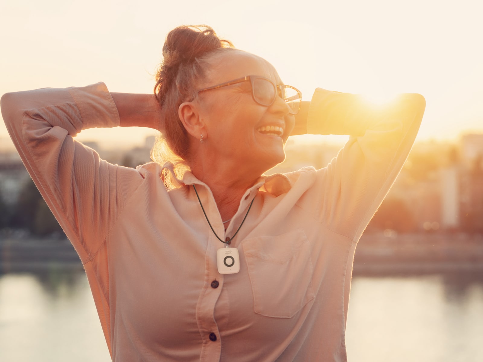 Woman at sunset wearing Medical Alert Mini Mobile System