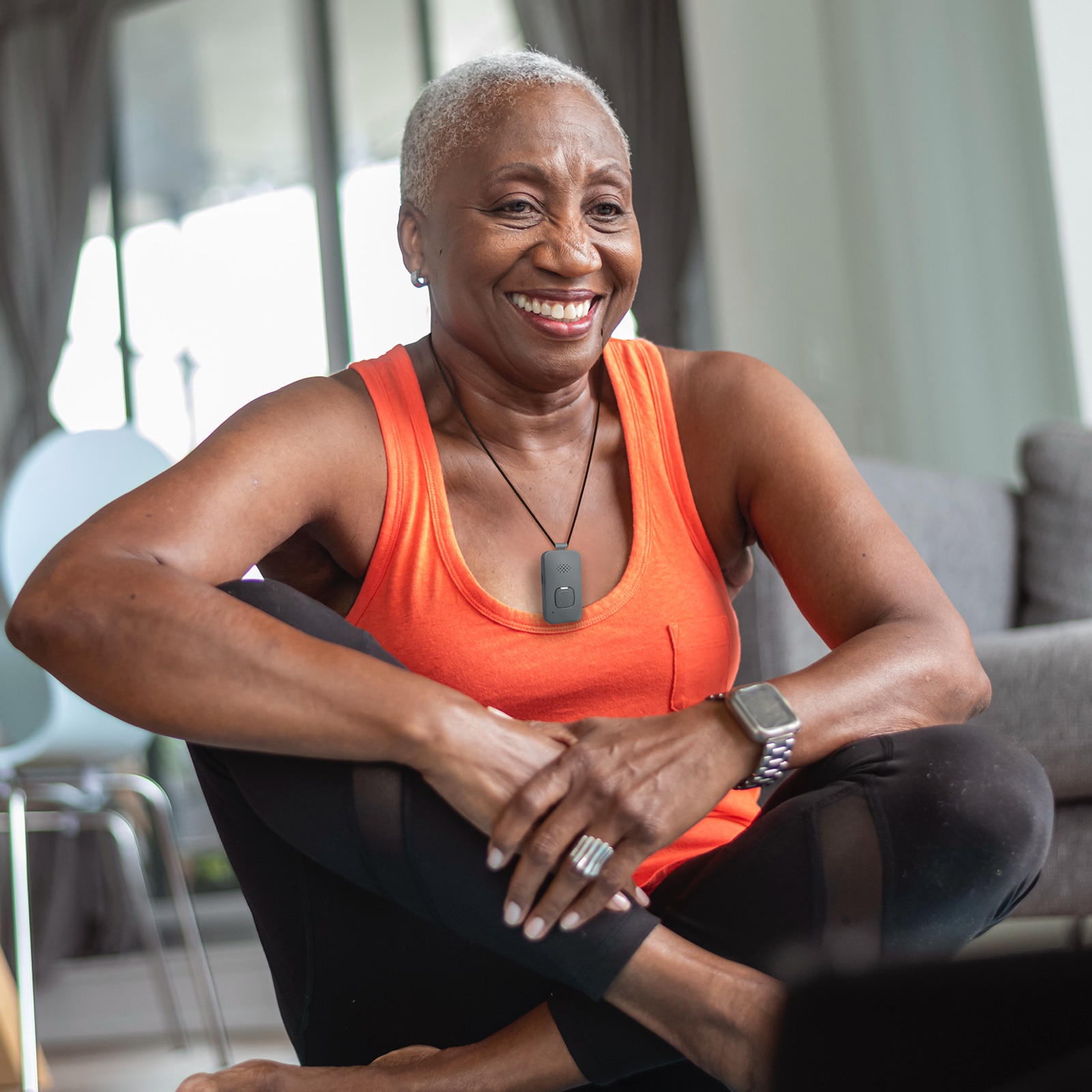 Woman doing yoga wearing Medical Alert Mobile System