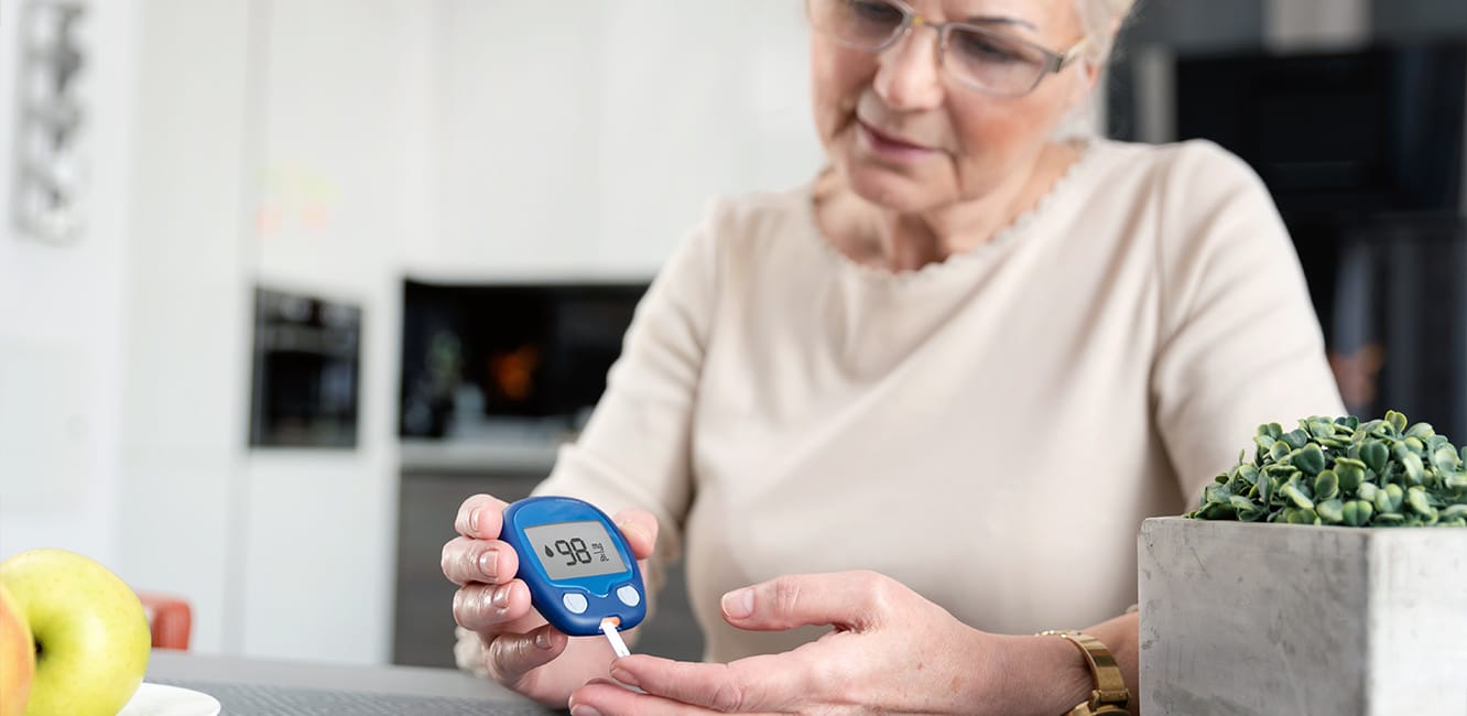 Woman with Diabetes Checking Blood Sugar with Glucometer