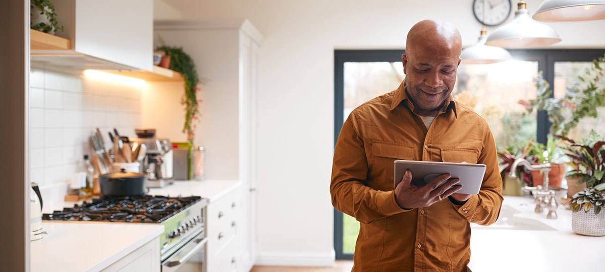 Man with Tablet in Kitchen