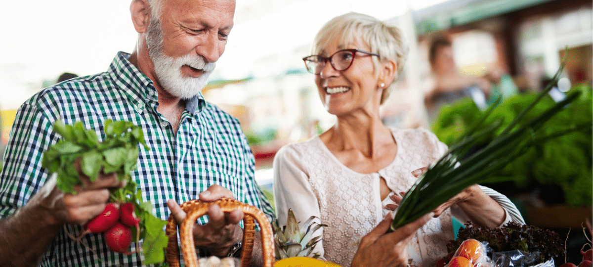 Man And Woman Buying Vegetables