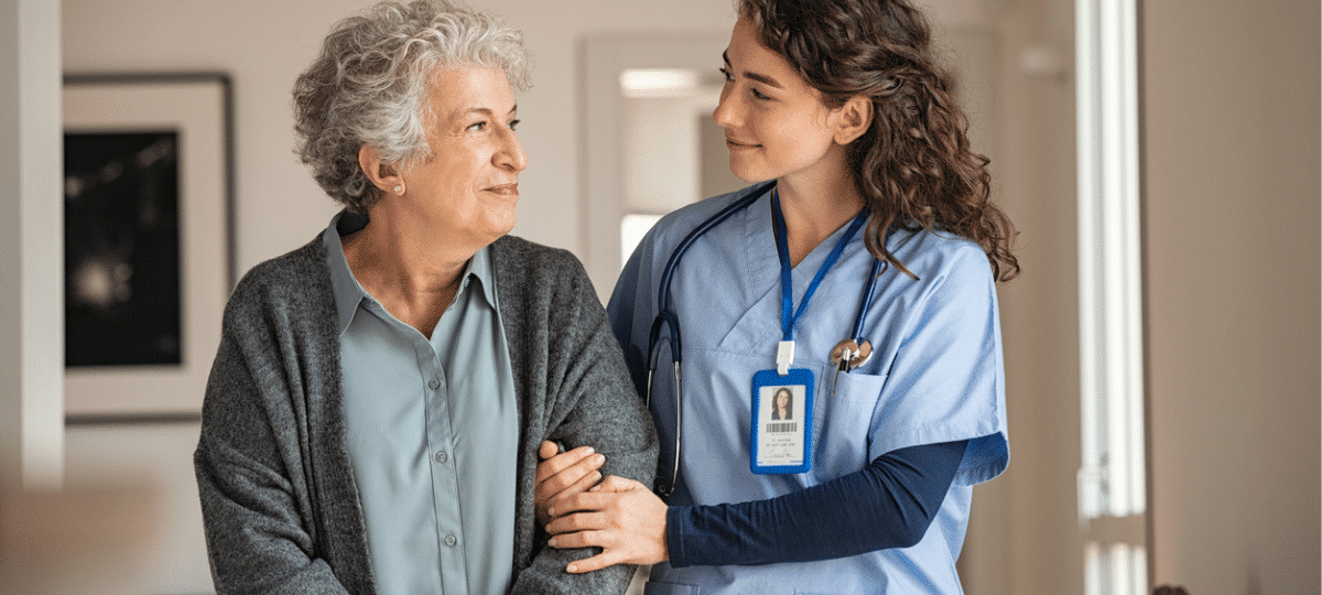 Senior Woman Walking with Nurse