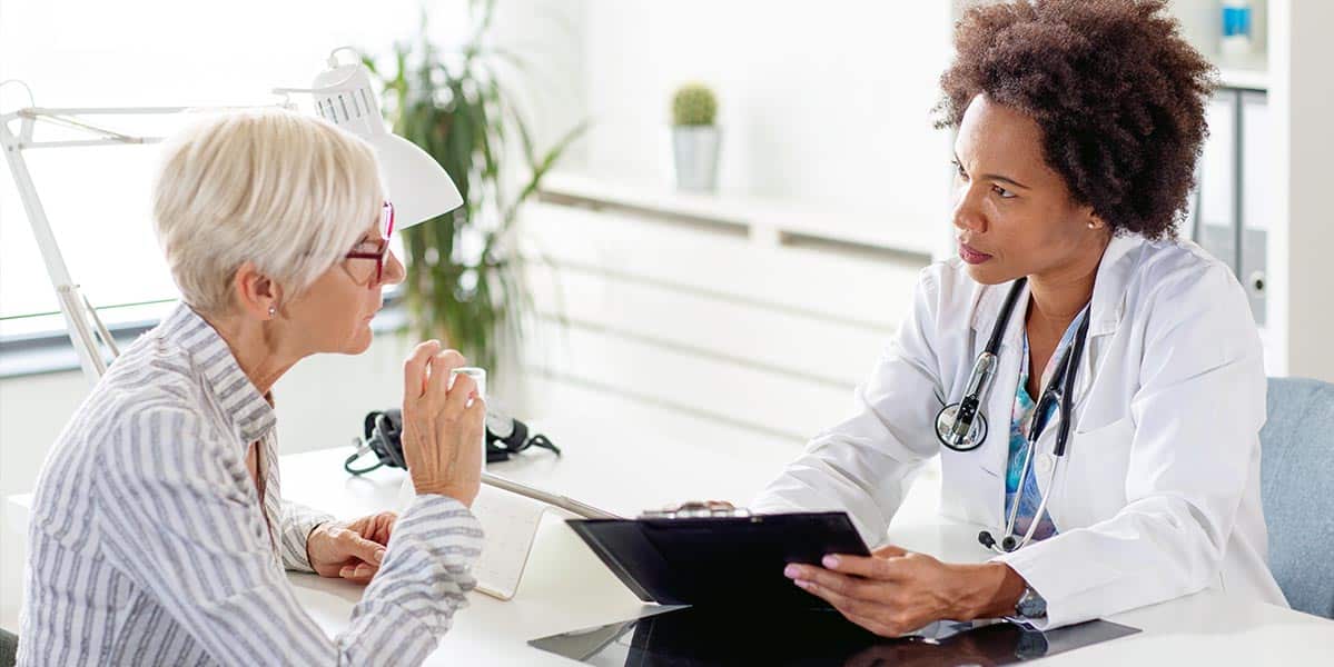 Woman Talking To Doctor