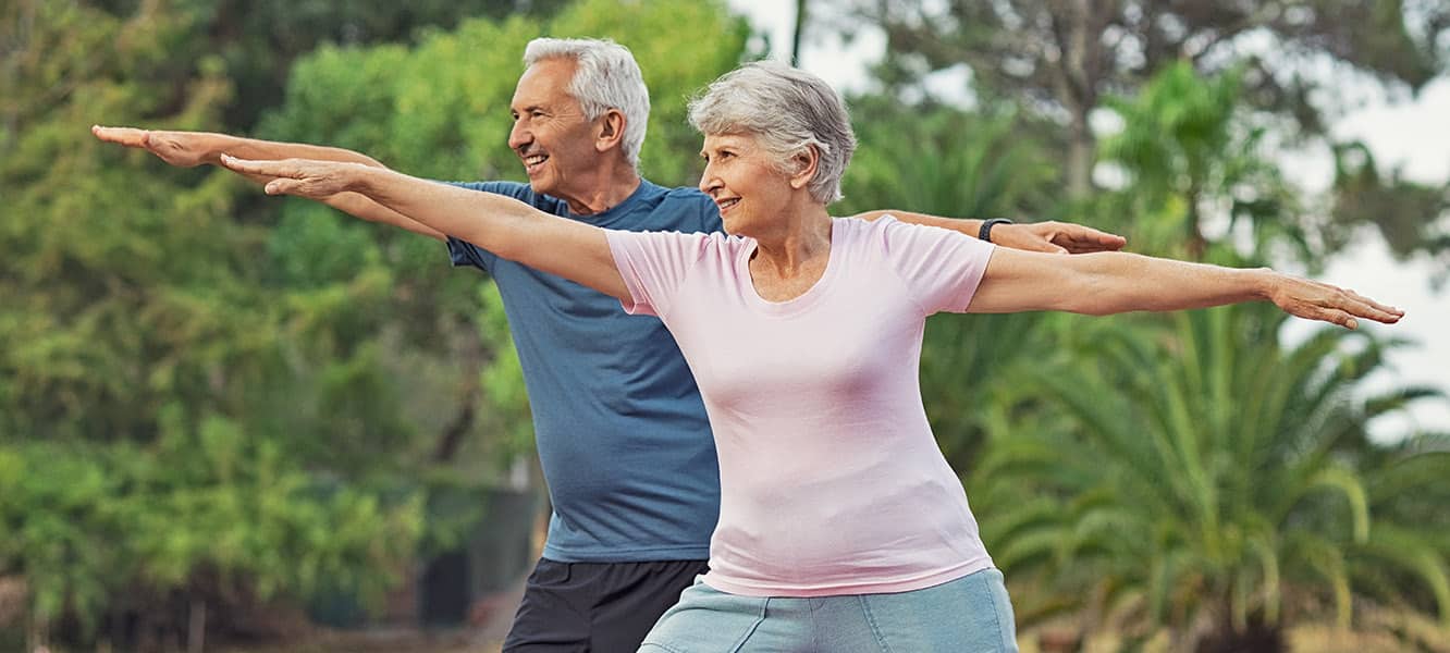 Couple Doing Yoga in Park